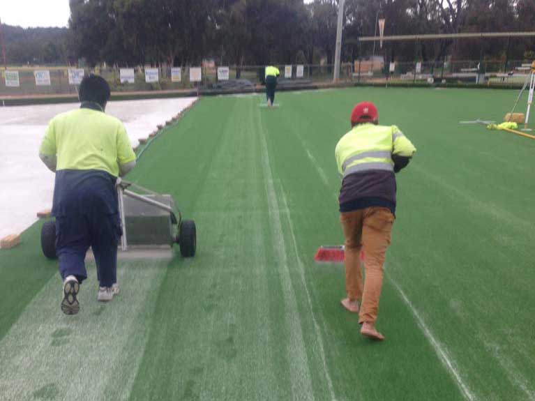 finishing synthetic grass on bowling green 