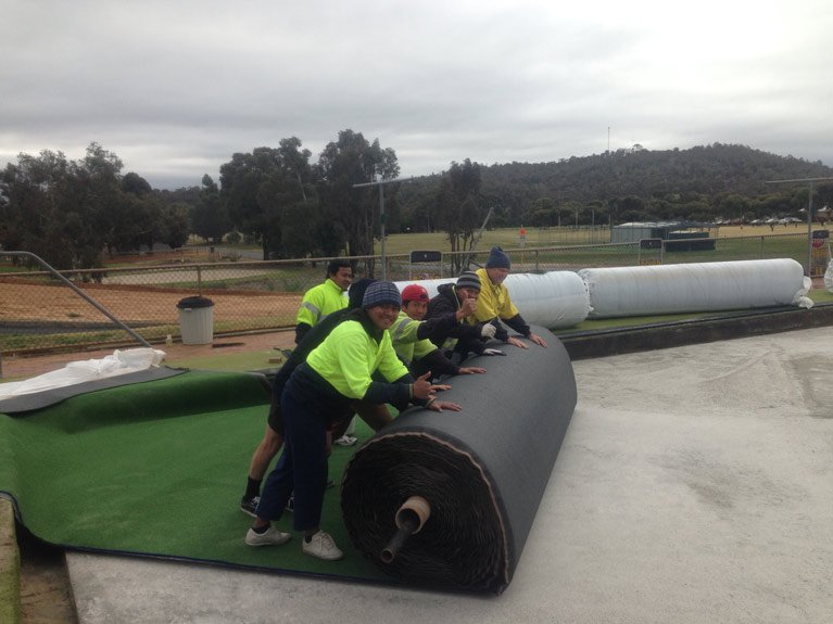 laying the synthetic grass on bowling green 